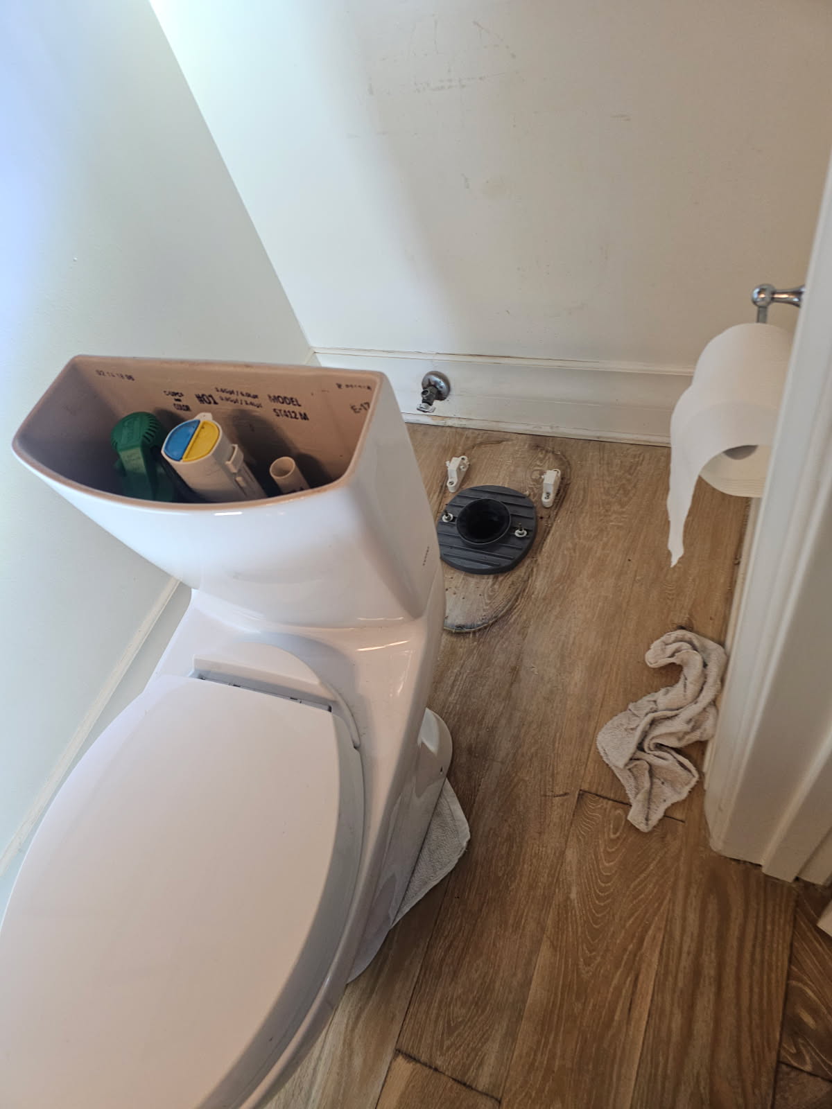 New toilet next to exposed wax-ring-ready closet flange during installation